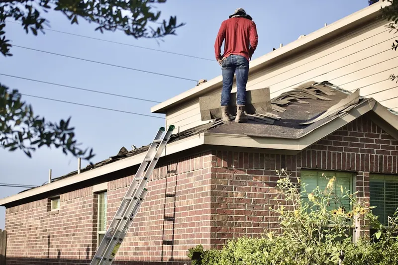 Professional roofer working on a residential roof in Country Acres